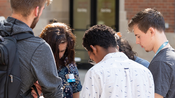 A group of students praying