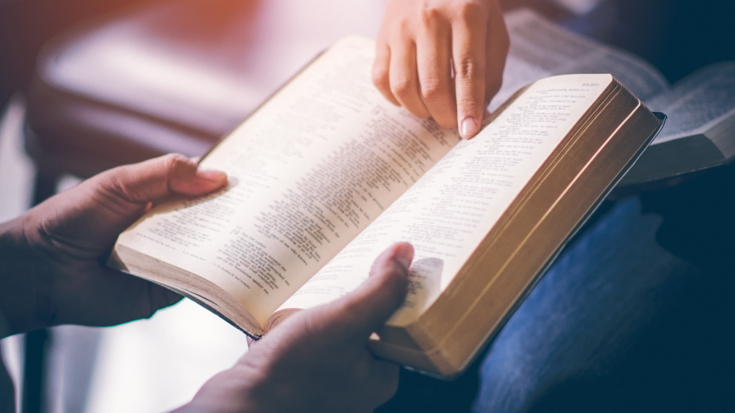 two people reading the Bible together