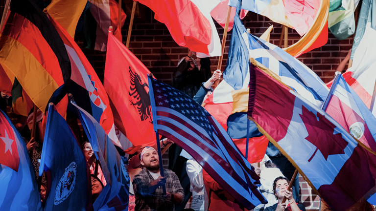 Students waving flags from different countries