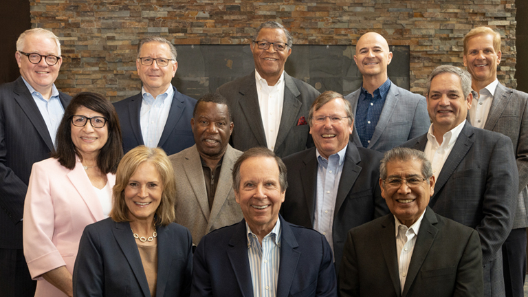 A group of men and women smiling.